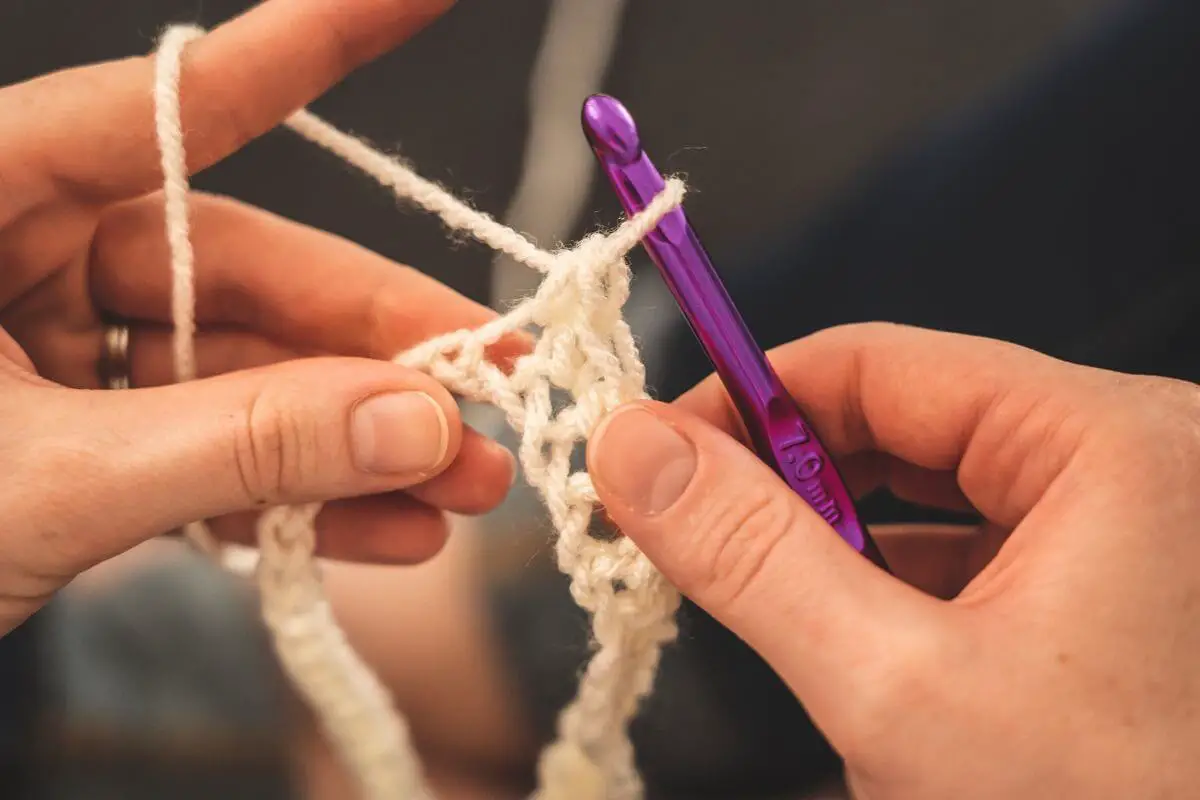 Sewing with a purple knitting neddle
